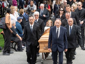 The casket of Quebec journalist, author and essayist Denise Bombardier is carried into the church for funeral services on Friday, July 14, 2023, in Montreal.