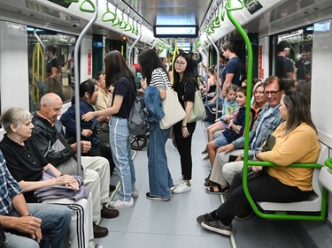 People take a ride on the REM light rail system in Montreal on Saturday, July 29, 2023.