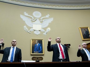 Ryan Graves, Americans for Safe Aerospace Executive Director, from left, U.S. Air Force (Ret.) Maj. David Grusch, and U.S. Navy (Ret.) Cmdr. David Fravor, are sworn in during a House Oversight and Accountability subcommittee hearing on UFOs, Wednesday, July 26, 2023, on Capitol Hill in Washington.