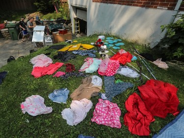 clothes laid out to dry on grass in front of a home