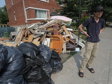 a man walks past flood-damaged debris in ndg