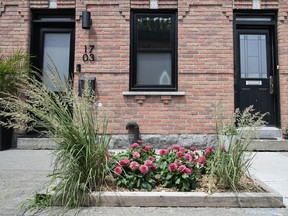 A sidewalk garden is shown in the Pointe-St-Charles borough of Montreal, Sunday, July 2, 2023. More and more gardens are sprouting up in the city where people plant flowers, vegetables and trees.