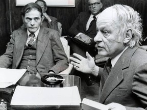 A black and white photo shows Ghislain Dufour and René Lévesque sitting at a table