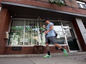 A blurry man is walking past a storefront that is actually a drug prevention centre.