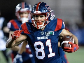 Tyson Philpot carries the football during a CFL game