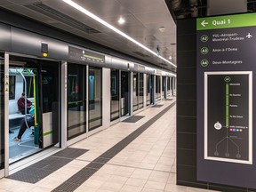 An REM platform with a train waiting, doors open.
