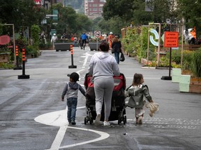 a woman and group of children on a pedestrian only street