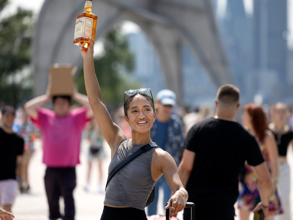 A vendor sells shots of Jack Daniels during Osheaga in Montreal on Friday, Aug. 4, 2023.