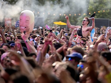 a fan crowdsurfs at osheaga