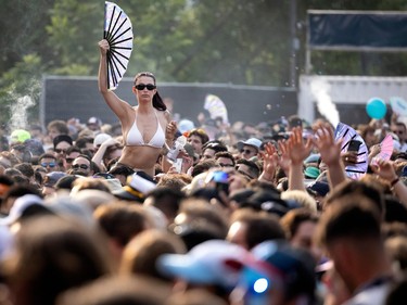 a fan crowdsurfs at osheaga