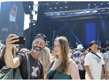 Jaiden poses for a picture with her father, Scott, as they arrive at Osheaga in Montreal, on Sunday, Aug. 6, 2023. They travelled from Calgary to attend the festival.