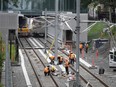 Workers on the tracks outside a train station