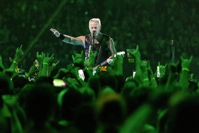 James Hetfield is seen through a sea of fans during a Metallica concert