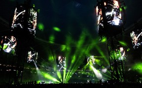 The Olympic Stadium is lit up in green during a Metallica concert