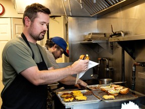 Two chefs cook burgers in a Montreal restaurant