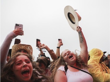 Women enjoy the music of Elle King at the Lasso country-music festival at Parc Jean-Drapeau in Montreal on Saturday, Aug. 19, 2023.