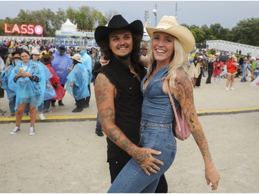 Partners Nevin Senechal and Sandrine Lefort at the Lasso country-music festival at Parc Jean-Drapeau in Montreal on Saturday, Aug. 19, 2023.