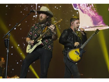 John Osborne Left) and T.J. Osborne of the Brothers Osborne perform at the Lasso country-music festival at Parc Jean-Drapeau in Montreal on Saturday, Aug. 19, 2023.