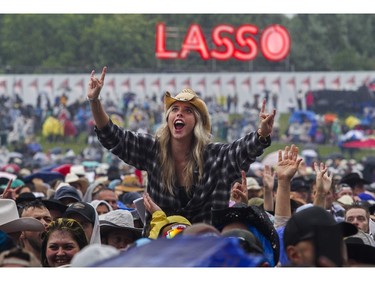 A woman enjoys the music of Elle King at the Lasso country-music festival at Parc Jean-Drapeau in Montreal on Saturday, Aug. 19, 2023.