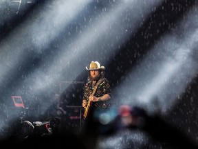 John Osborne of the Brothers Osborne performs as rain falls at the Lasso country music festival at Parc Jean-Drapeau in Montreal on Saturday, Aug. 19, 2023.