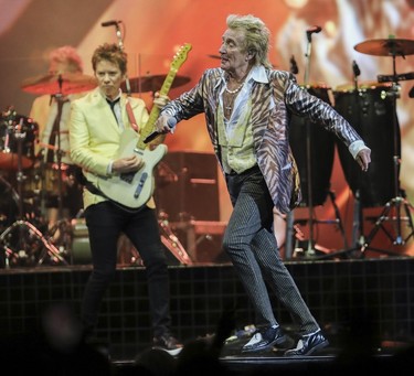 Rod Stewart strutting across stage during a concert