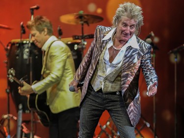 Rod Stewart gestures toward the crowd during a concert