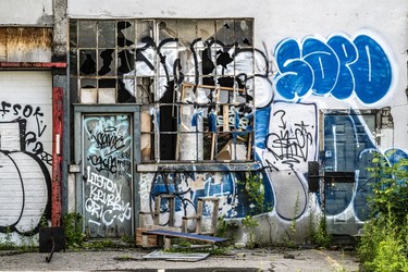 Mostly blue-and-white graffiti on an abandoned building on St-Patrick.