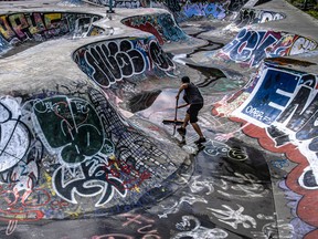 Skateboarder Guillaume Lecuyer, surrounded by colourful graffiti, sweeps up at the skateboard park on Saint-Laurent Blvd.