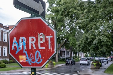 Blue graffiti on a red stop sign at the corner of Davaar and Lajoie Aves. in Outremont.