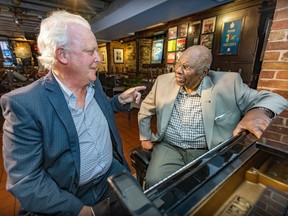 Jim West, left, whose label Justin Time Records is celebrating its 40th anniversary, and jazz pianist Oliver Jones reminisce at the Upstairs Jazz Bar in Montreal on Monday, Aug. 28, 2023.