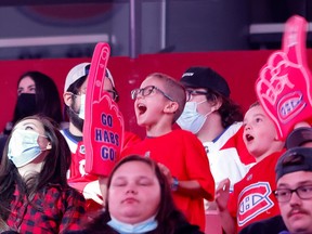 Young Canadiens fans cheers holding foam gloves