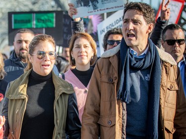 Justin Trudeau and Sophie Grégoire Trudeau take part in a protest
