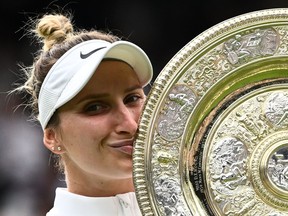 Czech Republic's Marketa Vondrousova celebrates as she kisses the Venus Rosewater Dish trophy during the prize ceremony after winning the women's singles final tennis match against Tunisia's Ons Jabeur at the 2023 Wimbledon Championships at The All England Lawn Tennis Club in Wimbledon, London, on July 15, 2023.