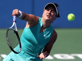 Bianca Andreescu hits a tennis ball
