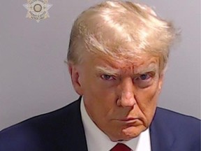 In this handout provided by the Fulton County Sheriff's Office, former U.S. president Donald Trump poses for his booking photo at the Fulton County Jail on Aug. 24, 2023 in Atlanta, Georgia. Trump was booked on 13 charges related to an alleged plan to overturn the results of the 2020 presidential election in Georgia. Trump and 18 others facing felony charges have been ordered to turn themselves in to the Fulton County Jail by Aug. 25.