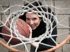 Annie Larouche looks through a basketball net