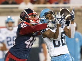 Alouettes defensive-back Kabion Ento contests a catch by Argonauts wide-receiver Damonte Coxie.