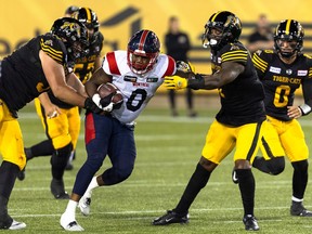 Alouettes rush end Shawn Lemon (0) carries the ball following an interception during second half CFL football game action against the Tiger-Cats in Hamilton on Saturday, Aug. 5, 2023.