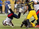 Montreal Alouettes running back William Stanback (31) is taken down by Hamilton Tiger-Cats linebacker Simoni Lawrence (21) during first half CFL football game action in Hamilton, Ont. on Saturday, August 5, 2023.