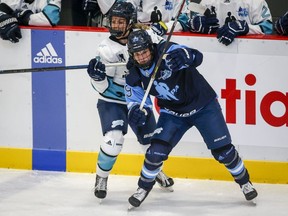 The Professional Women's Hockey League (PWHL) will open its inaugural season in January with teams in Toronto, Montreal, Ottawa, Boston, Minneapolis-St. Paul and the New York City area. Team Bauer Marie-Philip Poulin, right, checks Team Sonnet Nicole Kosta during first period PWHPA Dream Tour hockey action in Calgary, Monday, May 24, 2021.