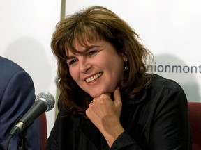 Diane Lemieux smiles in front of a microphone