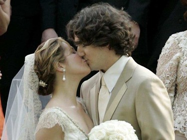 Justin Trudeau kisses Sophie Grégoire Trudeau while wearing wedding outfits