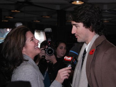 Sophie Grégoire Trudeau laughs as she holds an eTalk microphone in front of Justin Trudeau