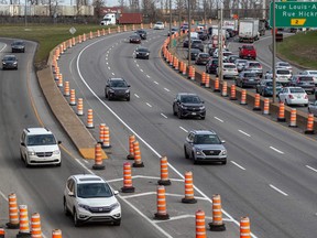 cars on a highway with construction cones