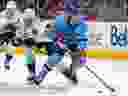 Canadiens' Juraj Slafkovsky skates away from Kraken's Ryan Donato during game at the Bell Centre in January.