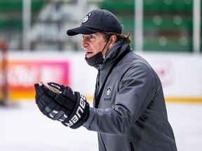 Mike Babcock sports a dark hat and gloves while running a practice at the Merlis Belsher Arena in Saskatoon last year.