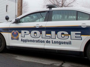 The side of a police car is seen in this photo with the writing POLICE agglomeration de longueuil.