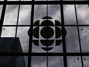 The CBC logo is seen in silhouette on a window