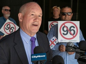 Andrew Caddell, head of the Task Force on Linguistic Policy, is shown outside the Montreal courthouse with supporters holding signs against Bill 96.