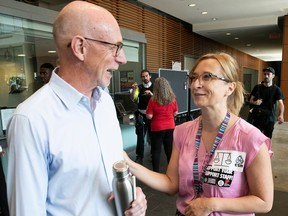 Beata Tararuj, right, who initiated a petition by Concordia University staffers against a back-to-campus order, speaks with university president Graham Carr during a coffee get-together at the school's Engineering, Computer Science and Visual Arts Complex on Thursday, Sept. 7, 2023.